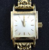 A lady`s late 1940`s 18ct gold Omega manual wind wrist watch, with square dial and baton numerals,