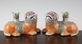 A pair of Chinese famille rose lion-dog vases, Daoguang period, each lion-dog in recumbent pose,