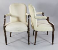 A pair of late 18th century French mahogany open armchairs, with tapering fluted legs