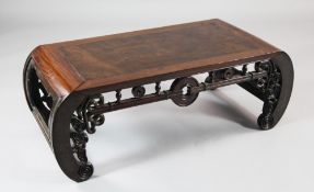 A Chinese rosewood opium table, pierced and carved with traditional motifs and shaped supports, L.