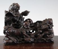 A Chinese rosewood lion-dog group, 19th century, with the figures of three lion-dogs chasing a