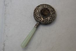 A Chinese jade and bowenite mounted hand mirror, the brown and grey jade boss, possibly Ming