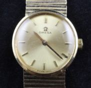 A lady`s 1960`s 9ct gold Omega manual wind wrist watch, with baton numerals, on integral 9ct gold