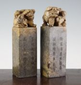 A pair of Chinese soapstone seals, 20th century, each surmounted by the figure of a lion-dog and two