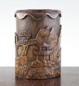 A Chinese bamboo brush pot, carved in relief with pavilion in a mountainous landscape and lotus,