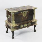 An Indian brass mounted hardwood chest on stand, with engraved brass decoration, single base drawer,
