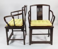 A pair of Chinese rosewood open armchairs, the shaped splat backs carved with a stylised shou