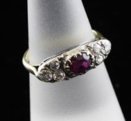 An early 20th century gold and silver, ruby and diamond cluster ring, set with central ruby and each