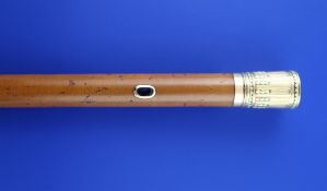 An 18th century French two colour gold topped malacca cane, with foliate decoration and cord recess,