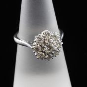 An 18ct white gold and platinum, diamond cluster ring, of flower head design, set with nine
