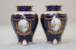 A pair of Royal Crown Derby small vases, painted by W.E.J. Dean, c.1915, painted with river