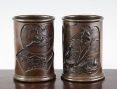 Two Japanese bronze cylindrical brush pots, 19th century, each cast in high relief to fan and