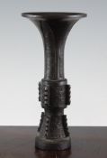 A Chinese archaistic bronze Gu vase, 17th / 18th century, decorated with bands of taotie masks and