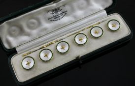 A cased set of six early 20th century 18ct gold, mother of pearl and green enamel dress buttons,