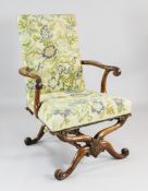An 18th century walnut open armchair, with bell flower and acanthus carved decoration, with floral