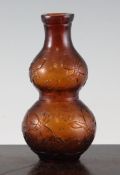 A Chinese amber glass double gourd vase, with gilt flake inclusions, relief decorated with