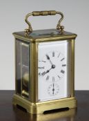 A French brass hour repeating carriage alarm clock, with enamelled dial and movement striking on a