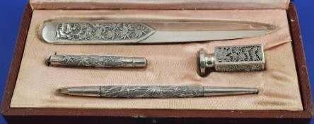 A cased Chinese silver four piece desk set, comprising letter opener, nib case, pen and seal,