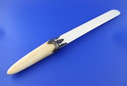 An Edwardian silver mounted ivory page turner, with boar`s tusk handle, Hilliard & Thomason,