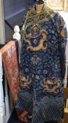 Three Chinese embroideries, early 20th century, a black satin robe with figural medallions, a