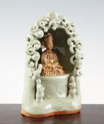 A Chinese celadon glazed porcelain shrine of the South Sea Guanyin, the figure seated in an arch