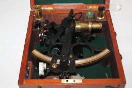 An H.Hughes & Son cased sextant, no.37462, with various lenses and fittings and a certificate from