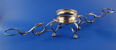 A George V silver strawberry, cream and sugar stand, with dolphin scroll supports, on claw and