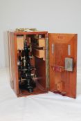 An early 20th century Leitz lacquered brass and black painted microscope, marked E. Leitz,