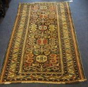 A 1920`s Caucasian rug, with five octagons in a field of stylised geometric motifs, on a