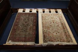 Two Isfahan design part silk rugs, both approx. 3ft 5in by 2ft 2in.