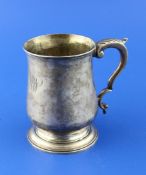 A George III silver mug, of baluster form, with acanthus leaf capped handle and later engraved