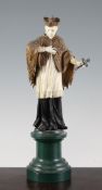 A late 19th century Bavarian carved ivory and softwood figure of a standing saint, holding a