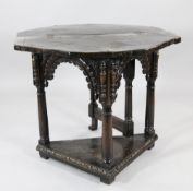A 17th century and later carved oak credence table, with canted fold over top, on gun barrel