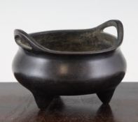 A Chinese bronze ding censer, probably 19th century, with high looped handles and three tapering