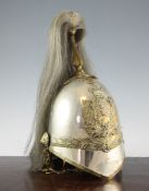 A British Military Albert pattern helmet, with horse hair plume and brass badge, underside inscribed