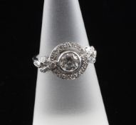 An 18ct white gold and diamond set cluster target ring, the central diamond weighing approximately