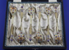 A cased set of six late 19th century Russian 84 zolotnik silver gilt and cloisonne enamel coffee