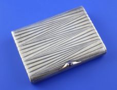 An early 20th century Russian 84 zolotnik silver cigarette case, with stylised ribbed decoration and