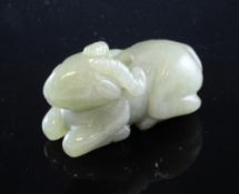 A Chinese green jade figure of a recumbent ram, Qing Dynasty, central piercing, 5.5cm.