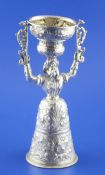 An unusual 19th century Hanau silver wager cup, modelled as a bearded man dressed as a lady, with