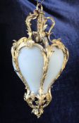 A French ormolu and opaline glass panelled hanging lantern, of inverted baluster shape with