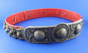 A late 19th century Russian 84 zolotnik silver and niello, red leather backed belt and buckle,