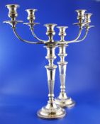 A pair of early 19th century Neo-Classical style Sheffield plate two-branch three-light