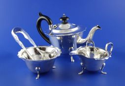 A George V silver three piece tea set, of circular form with shaped cut rims, Viner`s Ltd,