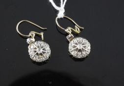 A pair of gold and diamond drop earrings, of circular form, each set with nine old cut diamonds.