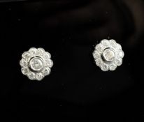 A pair of 18ct white gold and diamond cluster earrings, of flower head design.