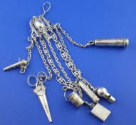 An early 20th century continental silver chatelaine with seven attachments, including whistle by