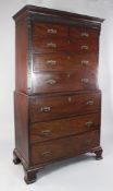 A George III mahogany secretaire chest on chest, with blind fret carved frieze and canted sides,