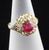 A late 19th/early 20th century 22ct gold ruby and diamond set cluster ring, of flowerhead design,