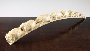 A Japanese ivory `elephant` bridge, early 20th century, carved with a procession of nine graduated